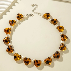 Detail of leopard print heart beads and white pearls on an elegant tiered necklace