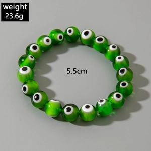 Detail view of green beaded evil eye bracelet with 23.6g weight and 5.5cm diameter