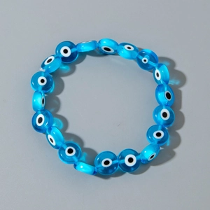 Detailed view of bohemian blue evil eye resin beads on an elastic stretch bracelet