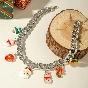 Close-up of festive Christmas charm necklace with resin Santa and snowman on silver chain