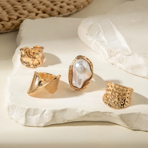 Set of 4 gold-tone rings featuring baroque pearl and irregular textured geometric designs