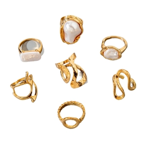Golden baroque pearl jewelry set with seven textured geometric rings and earrings