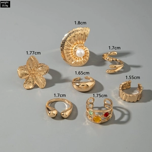 Detailed set of 7 gold-plated metal rings featuring baroque pearls and floral patterns