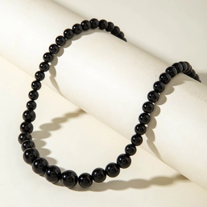 Macro view of gradient black beaded necklace featuring high-gloss acrylic round beads