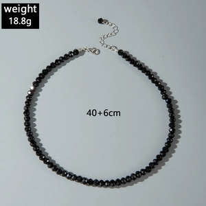 Detail of black faceted bead necklace with silver lobster clasp and extension chain