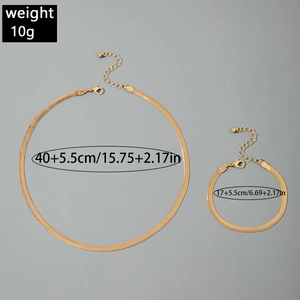 Detailed view of gold spiral collar necklace and bracelet set with lobster clasp closure