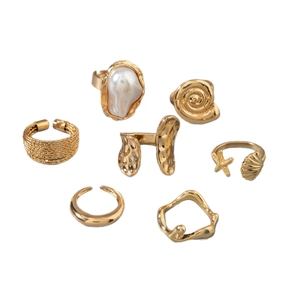 7-piece vintage gold ring set featuring baroque pearl and sea-themed geometric designs