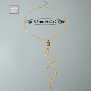 Detail view of adjustable gold snake chain Y-necklace with tassel and slide bead closure