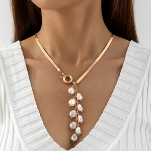 Detail of a gold snake chain necklace with a cluster of dangling freshwater pearls