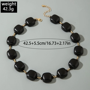 Detail view of chunky black matte square bead necklace with gold clasp and 42.5cm size