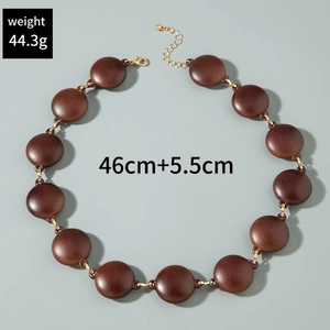Detail view of chunky brown acrylic bead necklace with gold rings, 46cm length and 44.3g
