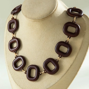 Close-up of retro brown acrylic chunky chain necklace with golden metallic links