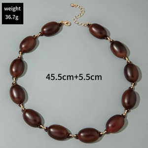 Detail view of brown acrylic link necklace showing length 45.5cm and weight 36.7g