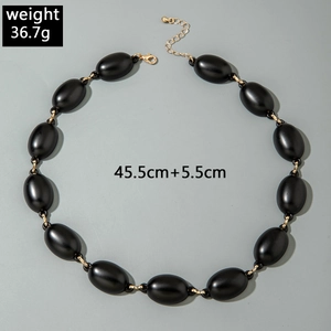 Macro view of chunky black acrylic link necklace showing 36.7g weight and dimensions