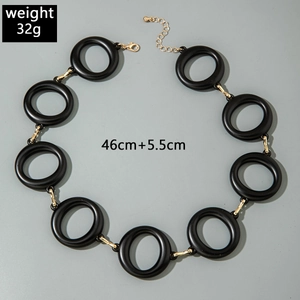 Detail of chunky black matte acrylic rings with gold metal links and 46cm chain length