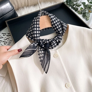 Leichtes schwarz-weiß gepunktetes Chiffon-Halstuch gestylt auf einer weißen Bluse