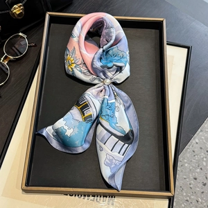 Elegant mulberry silk scarf with floral print and pearl buckle on a stylish tray