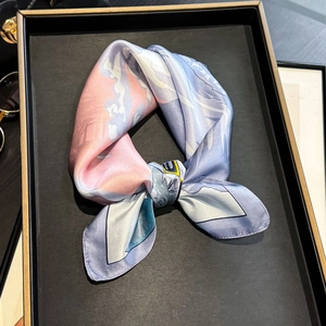 Close-up of a premium mulberry silk square scarf with colorful artistic prints in a bow shape