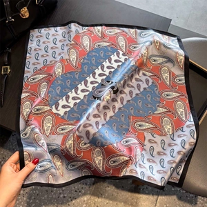 Elegant paisley silk square scarf in blue and red silk satin, styled with a handbag