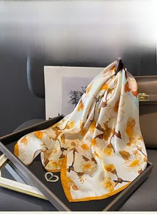 Detailed texture of elegant mulberry silk scarf with floral print and hand-rolled edges