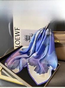 Detailed texture of blue floral mulberry silk square scarf on luxury fashion display