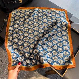 Premium silk square scarf with blue paisley print and orange border for elegant styling