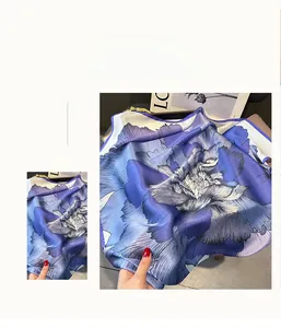 Close-up of lilac and deep blue silk scarf with watercolor floral print and natural luster