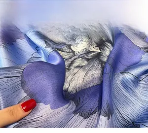 Macro detail of high-quality silk scarf showing durable hemmed edges and floral prints