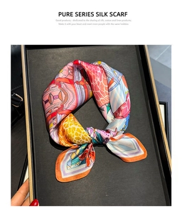 Detailed shot of a silk scarf tied in a bow with artistic floral patterns on a display tray