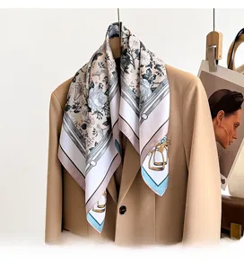 Detailed view of floral printed twill silk scarf tied elegantly on a professional suit