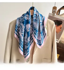 Detail of elegant French floral print silk scarf styled with a beige blazer