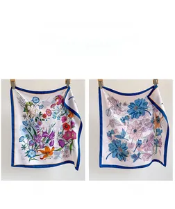Detail showing two-sided floral pattern and contrast edging on silk square scarf