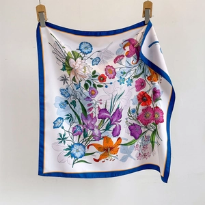 Elegant white square silk scarf with vibrant floral prints and navy blue borders