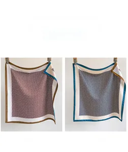 Detail of silk-like twill square scarves with geometric circle patterns in two colorways