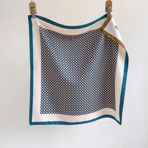 Elegant geometric chain print silk scarf in blue, gold and white on white background