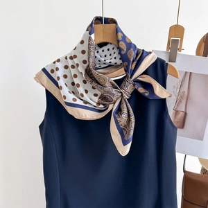 Detail of premium silk twill scarf with paisley and polka dot patterns in deep navy blue
