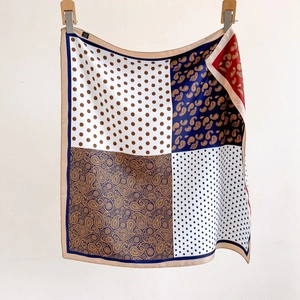 Premium twill silk scarf featuring cashew paisley patterns and polka dots with a soft drape