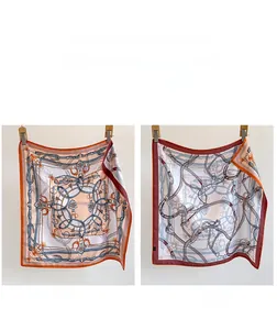 Detail showing double-sided silk scarf with chain pattern and contrast color display