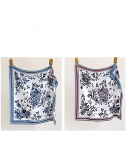 Detail of floral silk scarf featuring double-sided blue and purple flower patterns