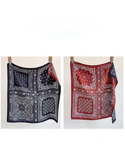 Detailed macro view of the double-sided paisley patterns on vintage black and red twill scarf