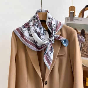 Floral silk scarf with butterfly print and striped border on camel blazer for women