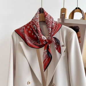 Elegant red paisley silk scarf for women tied on a white blazer as a stylish accessory