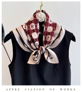 Detailed view of silk wool scarf featuring camellia and polka dot prints in burgundy