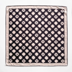 Black and white polka dot silk scarf featuring camellia patterns for professional neck styling