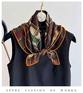 Detail of plaid silk wool scarf featuring a white camellia decor and orange borders