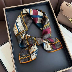 Silk wool checkered square scarf in vintage plaid pattern shown in a luxury display tray