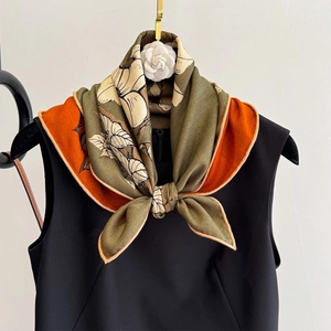 Elegant silk wool scarf with vintage floral print in olive and orange on black dress