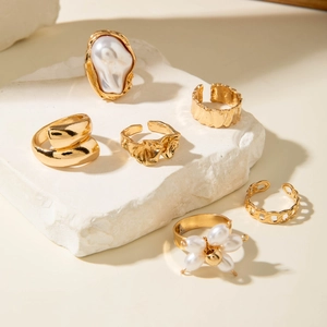 Set of 6 gold plated irregular pearl rings with hollow metal and textured lava designs