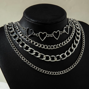 Detail of multi-layer hip-hop necklace with hollow hearts and chunky silver chains