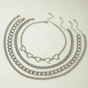 Detail of five-piece silver layering necklace set featuring chunky flat and heart chains